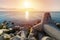 Beautiful sunset seascape, Breakwaters tetrapods ashore of pier, Cargo ships on the horizon, Travel dreams and motivation