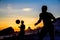 Beautiful sunset and silhouettes of men playing the ball at Copa