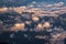 Beautiful sunset sky above clouds with dramatic light. Cabin view from airplane