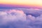 Beautiful sunset sky above clouds with nice dramatic light. View from airplane window