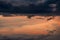 Beautiful sunset sky. Aircraft flying on dark and pastel sky. Art picture of sky at sunrise. Sunrise and fluffy clouds