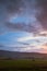Beautiful sunset sky. Landscape with cloudy sky, meadow and hill