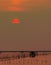 Beautiful sunset sky over the sea in the evening. The sun is obscured by some clouds at sunset. Fisher man hut of coastal fishing