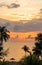 Beautiful sunset sky on the sea with silhouette trees. Morning sunrise on the beach of Desaru Coast, Malaysia