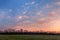 Beautiful sunset. Spring landscape with trees, blue sky and clouds