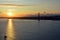 Beautiful sunset. Tejo river. 25th April bridge. Lisbon. Portugal. Almada. Clouds. Yacht. Boat. Sun. Colourfully. Sunlight. Light.