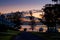 Beautiful sunset on tranquility lake with camper trailers silhouettes. Camping at holiday caravan park