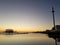 Beautiful sunset view at Brighton Pier with Brighton beach sea, sand and the highest and tallest building in the background.