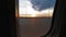 Beautiful sunset view of the ink porthole of an airplane. Airport work view from the plane at the time of movement