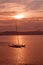 Beautiful sunset view over Palma bay with moored sailboat and airplane