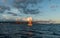 Beautiful sunset vista with a sailboat in the foreground off the coast of Honolulu on Oahu