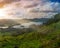 Beautiful sunset volcanic lake among mountains with green lush a