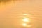 Beautiful sunset water background. The waves on the surface of the river. At twilight times and reflections. Golden and orange