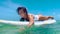 Beautiful surfer girl sitting on surfboard smiling In the water. Slow Motion