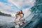 Beautiful surfer girl on surfboard. Woman in ocean during surfing. Surfer and barrel wave