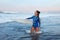Beautiful Surfer Girl. Surfing Woman With Surfboard Standing In Ocean. Brunette In Blue Wetsuit Waiting Wave.