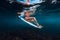 Beautiful surfer woman sit at surfboard underwater in ocean