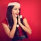 Beautiful surprising woman with open mouth in Santa Claus Christ