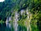 Beautiful swan lake with rocky shore in Alps.