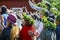 Beautiful swedish kid wearing colourful leave crown with mom is enjoying traditional decoration of mid summer day