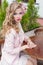 Beautiful sweet girl with hair and make-up color bright sitting at a table at an outdoor cafe and waiting for your order