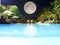 Beautiful swimming pool at night view with full moon umbrella and chair around