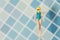 Beautiful swimsuit Women plastic toy top view on blue background