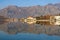 Beautiful symmetrical landscape where mountains and coast are reflected in water. Montenegro, Bay of Kotor, Dobrota town