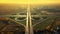 Beautiful symmetrical road junction, cloverleaf interchange, surreal aerial flight in the early morning light of the