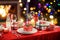 Beautiful table setting for Christmas party or New Year celebration at home. Cozy room with a fireplace and Christmas tree in a