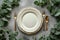 Beautiful table setting with white empty plate and gold cutlery