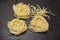 Beautiful Tagliatelle homemade Italian pasta from durum wheat on stone background, closeup
