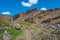 Beautiful and tall Icelandic waterfall Hengifoss and hiking trail to it, Iceland, summer, sunny day, blue sky