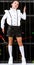 A beautiful and tall schoolgirl in a white blouse, black shorts, socks and sports shoes poses against the background of an iron