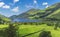 the beautiful Talyllyn Glacier Lake in North Wales (Great Britain) in summer with blue sky and green grass