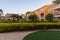 Beautiful Tamarijn hotel area view. Green bushes and plants and yellow buildings on blue sky background.