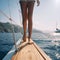 Beautiful tanned female legs on board yacht against backdrop of a beautiful seascape,