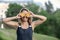 Beautiful tanned happy girl with orange slices in front of summer in nature.