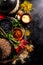 Beautiful Tasty Appetizing Ingredients Spices Grocery for Cooking Healthy Kitchen. Dark Black Background Top View. Flat Lay.