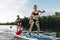 beautiful tattooed women surfing on paddleboards together