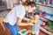 Beautiful teacher and toddler using alarm clock at kindergarden