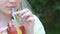 Beautiful teen drinking lemonade with strawberry