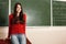 Beautiful teen girl high achiever in classroom near desk