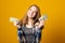 Beautiful teen girl holding dollars. Happy girl holding money banknotes and celebrating