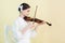 beautiful teen musician in white outfit playing violin