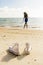 Beautiful teenage black girl in white sneakers on the sand of be