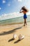 Beautiful teenage black girl in white sneakers on the sand of be