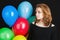 Beautiful teenage blond girl with balloons