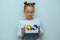 Beautiful teenage girl with hair bun holding baubles decoration for christmas tree.