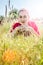 Beautiful teenage girl lying down in grass in foreground